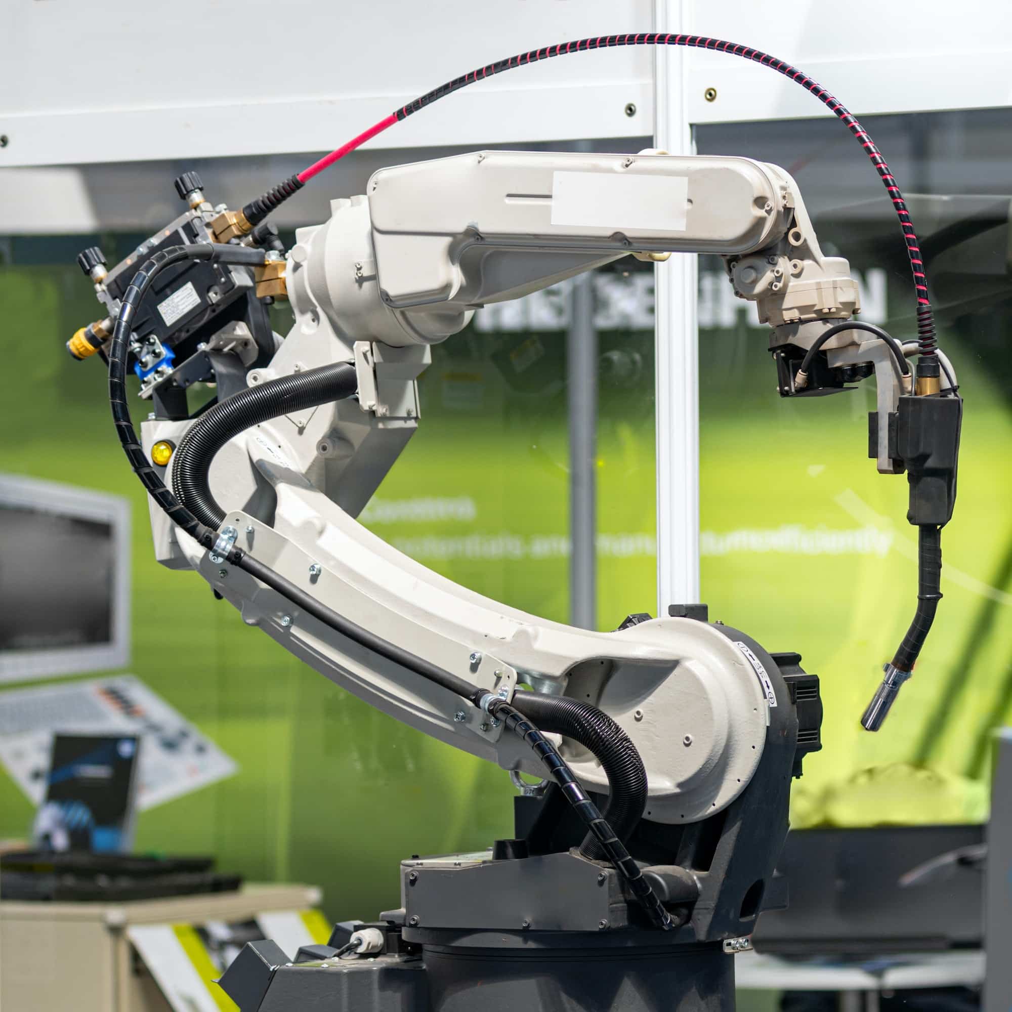 Robotic arm welding system in a manufacturing production plant